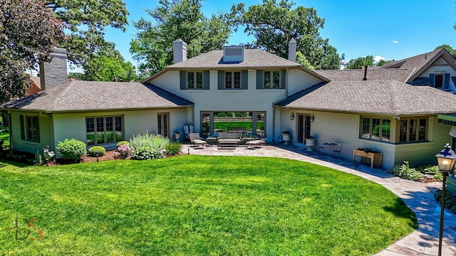 rear view of property featuring a patio area and a lawn