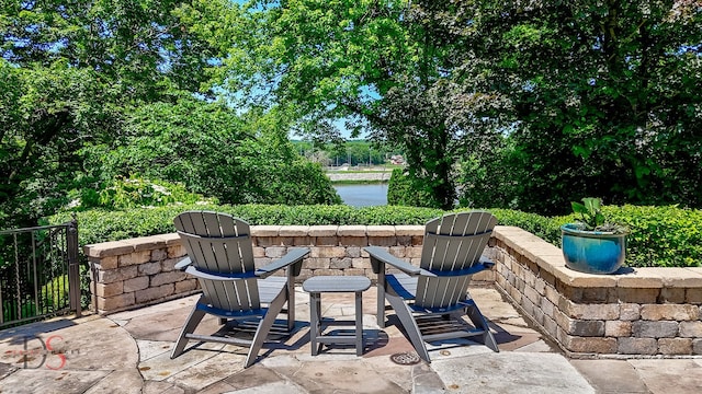 view of patio featuring a water view