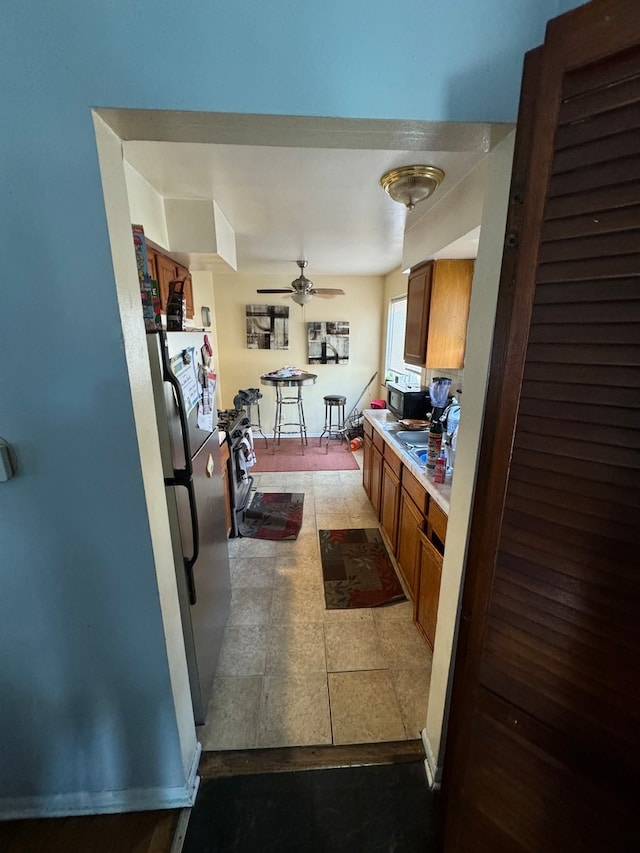 kitchen with stainless steel refrigerator and ceiling fan