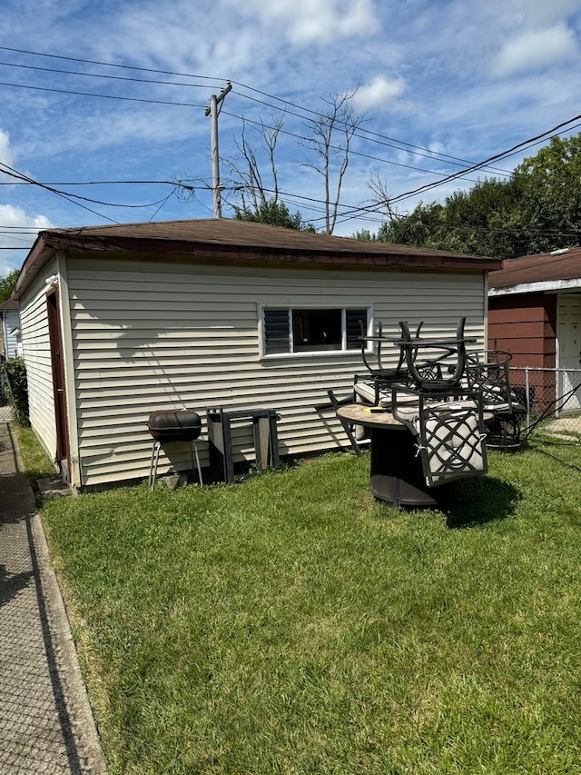 rear view of house featuring a yard