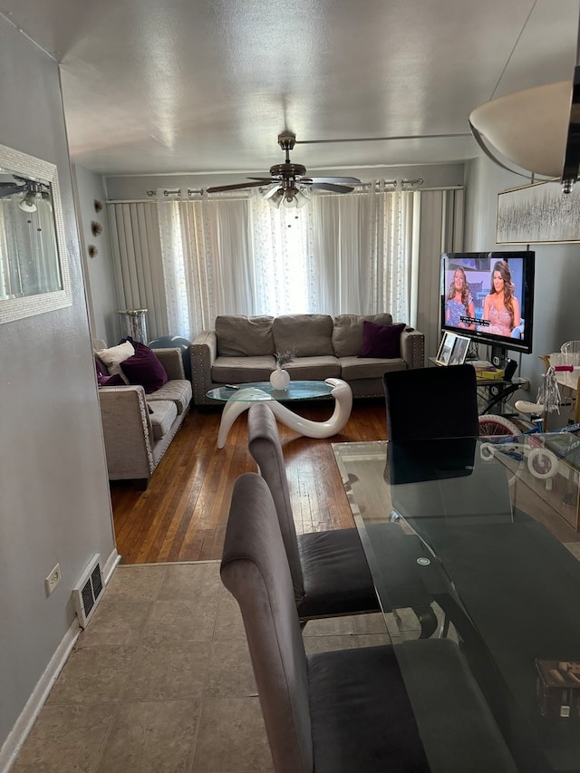 living room featuring ceiling fan and wood-type flooring