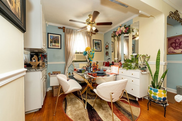 interior space featuring hardwood / wood-style flooring, ceiling fan, and crown molding