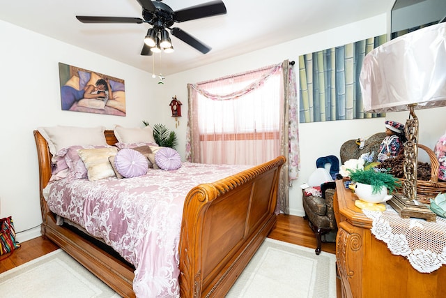 bedroom with ceiling fan and wood-type flooring