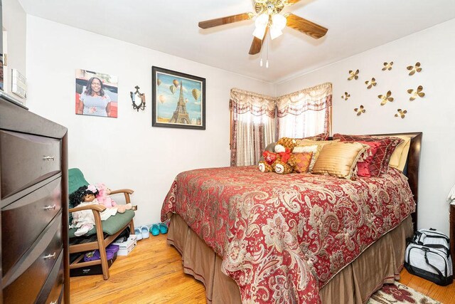 bedroom with ceiling fan and hardwood / wood-style floors