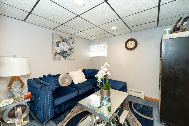 living room featuring carpet, a baseboard radiator, and a paneled ceiling