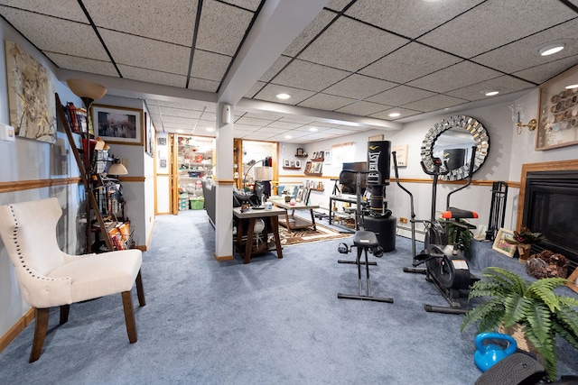 workout room featuring carpet floors and a drop ceiling