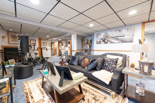 living room with carpet flooring and a drop ceiling