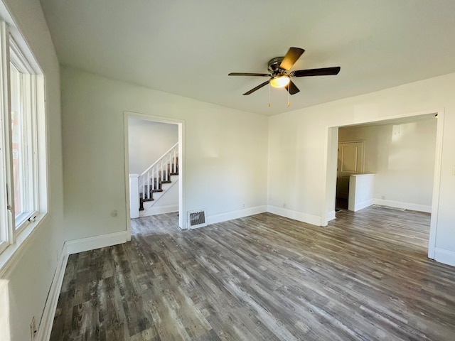 empty room with dark hardwood / wood-style floors and ceiling fan