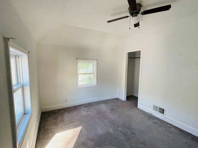 carpeted spare room with lofted ceiling and ceiling fan