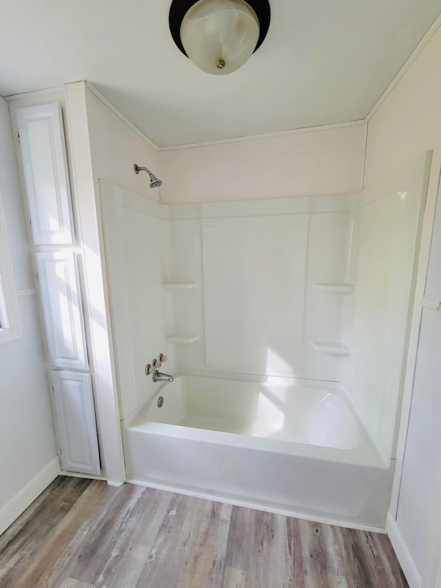 bathroom with shower / washtub combination and wood-type flooring