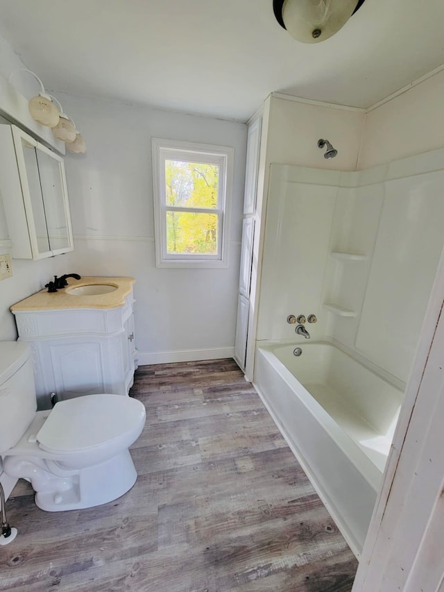 full bathroom featuring vanity, toilet, bathtub / shower combination, and hardwood / wood-style flooring