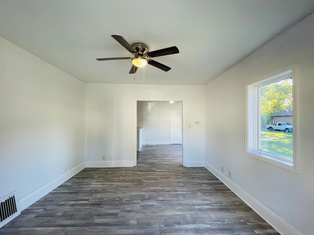 spare room with ceiling fan and dark hardwood / wood-style flooring