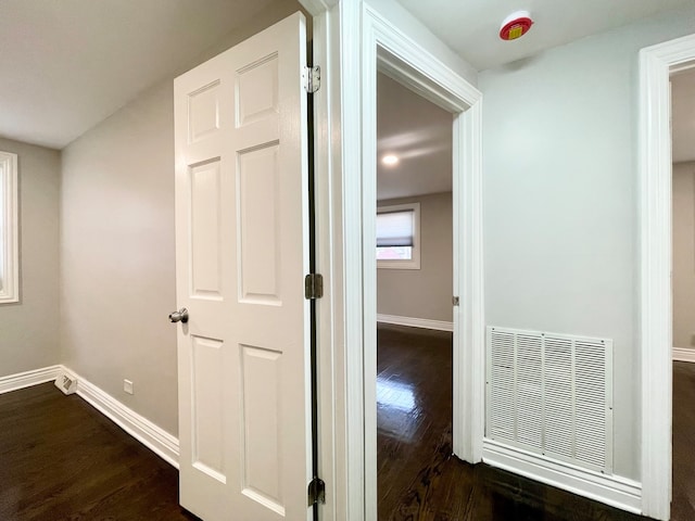 corridor featuring dark hardwood / wood-style flooring