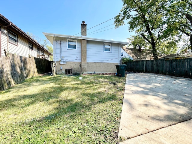 rear view of property with a yard, a patio area, and central air condition unit