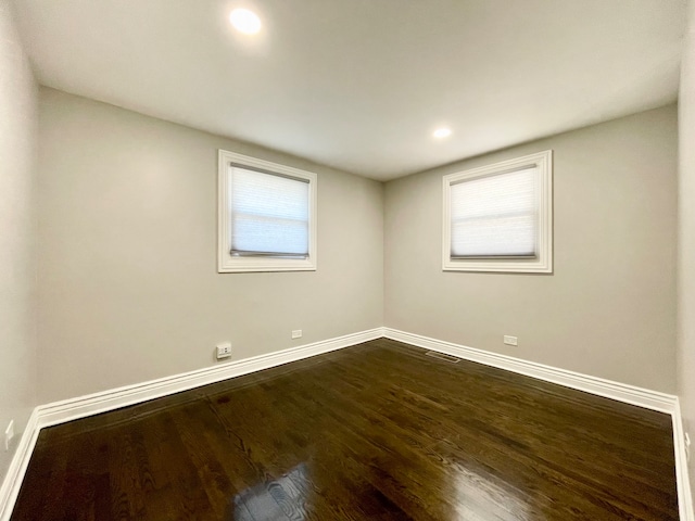 empty room featuring dark wood-type flooring