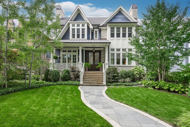 view of front of property with french doors and a front lawn