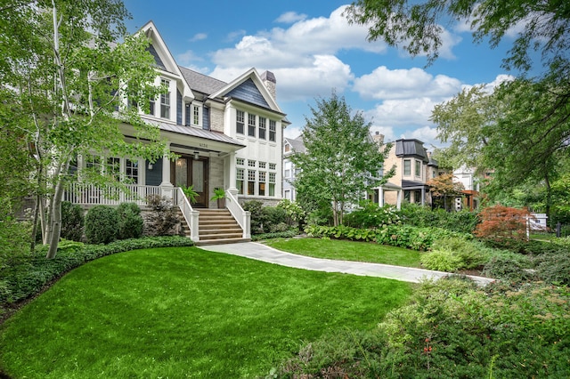 view of front of property with a front lawn and covered porch