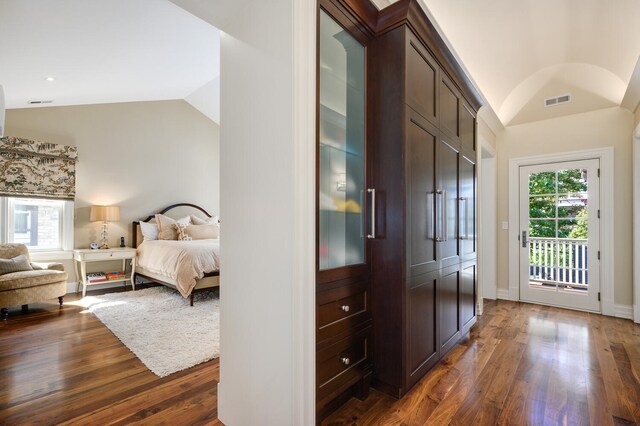 interior space featuring dark wood-type flooring and lofted ceiling