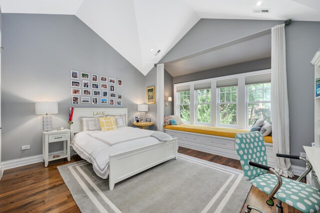 bedroom featuring high vaulted ceiling and dark hardwood / wood-style flooring