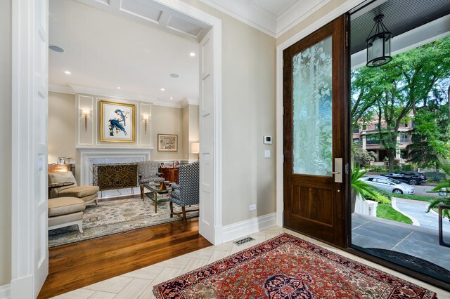 entrance foyer featuring ornamental molding