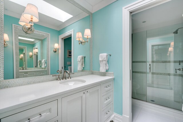 bathroom with vanity, a skylight, tile patterned flooring, and an enclosed shower