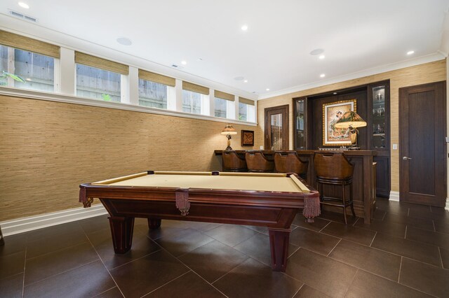 game room featuring pool table, ornamental molding, and bar area