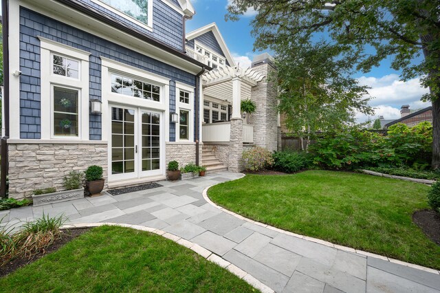 exterior space with french doors and a pergola