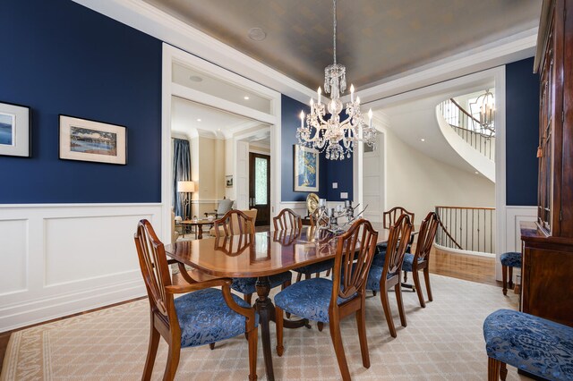 dining room with light hardwood / wood-style floors and ornamental molding