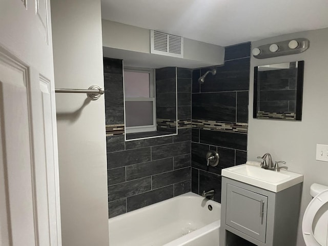 full bathroom with vanity, toilet, and tiled shower / bath