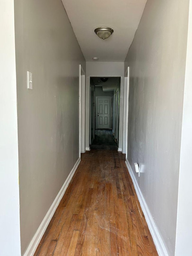 hallway with hardwood / wood-style flooring