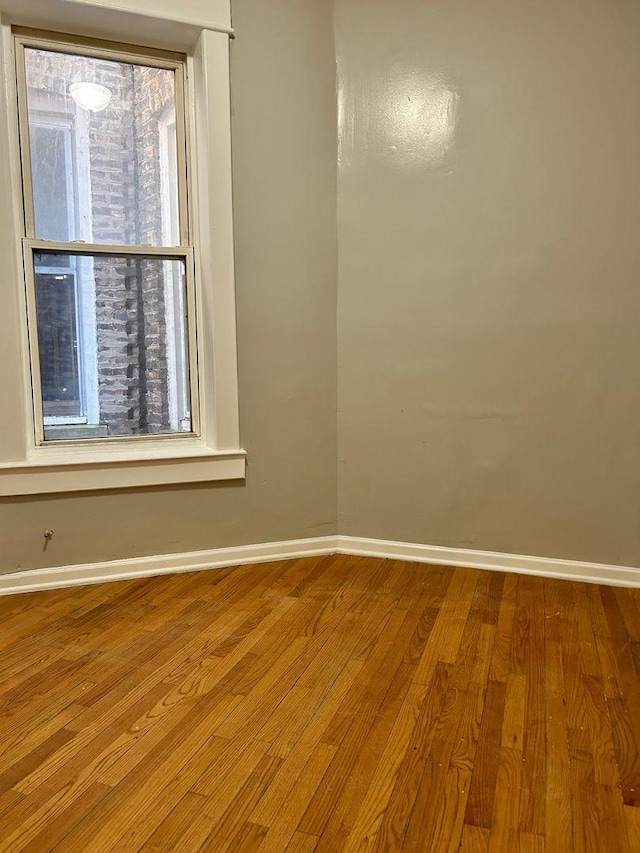 empty room with hardwood / wood-style flooring