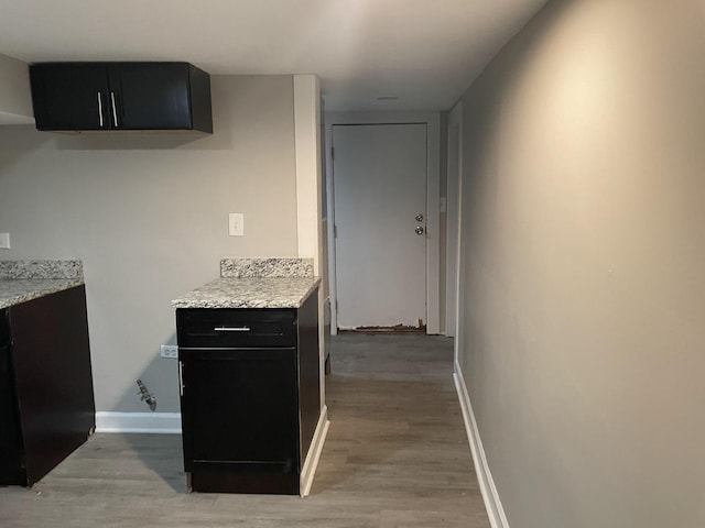 kitchen featuring light stone countertops and light hardwood / wood-style flooring