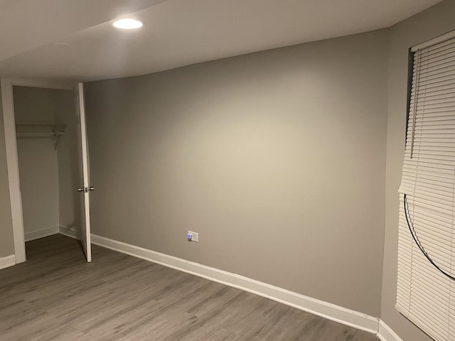 unfurnished bedroom featuring hardwood / wood-style floors and a closet