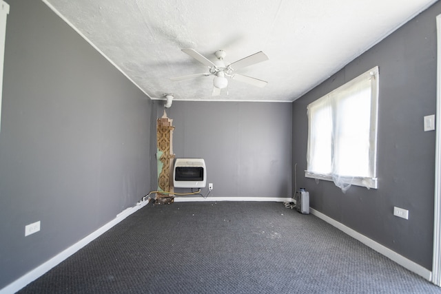 empty room with carpet flooring, ceiling fan, and a textured ceiling