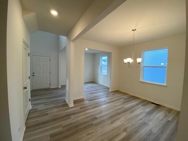 interior space with a chandelier and hardwood / wood-style floors