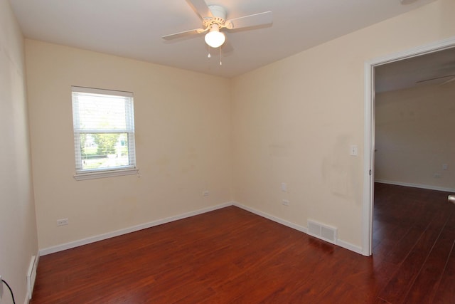 spare room featuring ceiling fan and dark hardwood / wood-style flooring