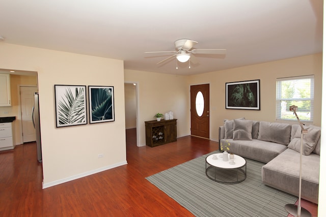 living room featuring ceiling fan and dark hardwood / wood-style flooring