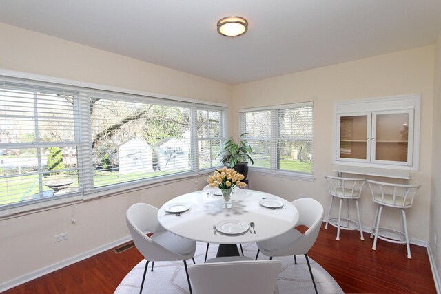 dining room with dark hardwood / wood-style flooring