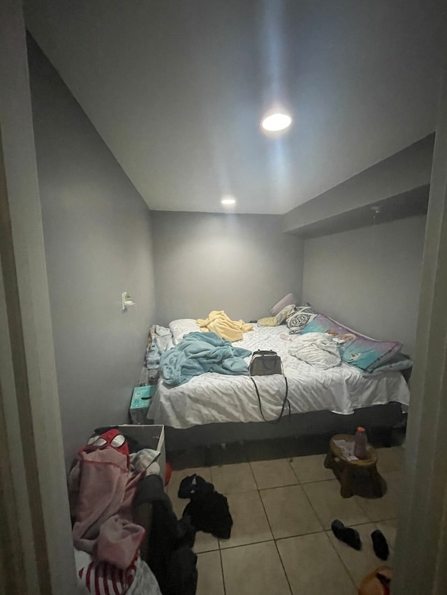 tiled bedroom featuring lofted ceiling