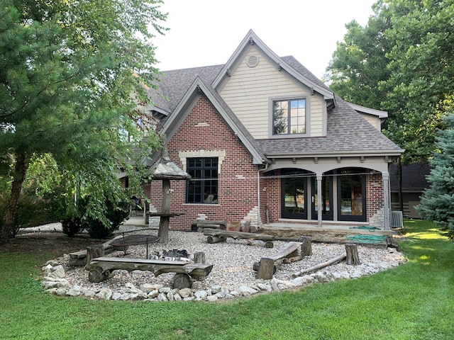 back of house featuring french doors, a lawn, and central AC