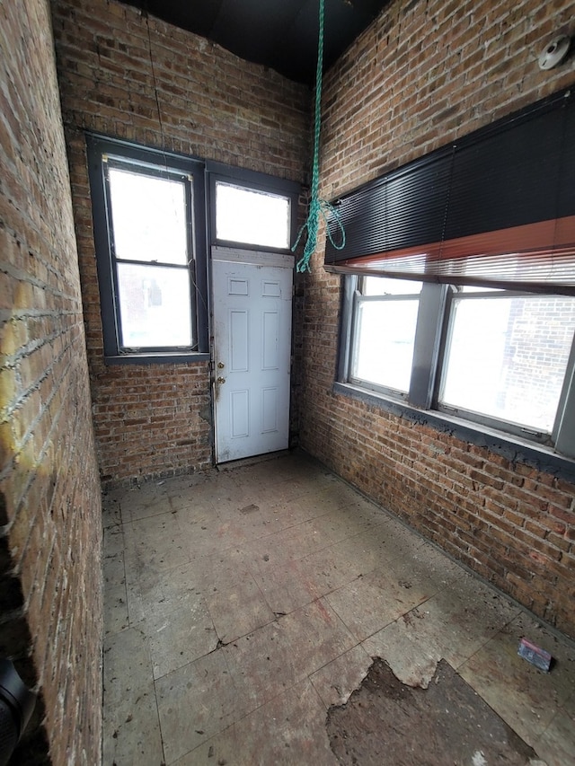 foyer with brick wall