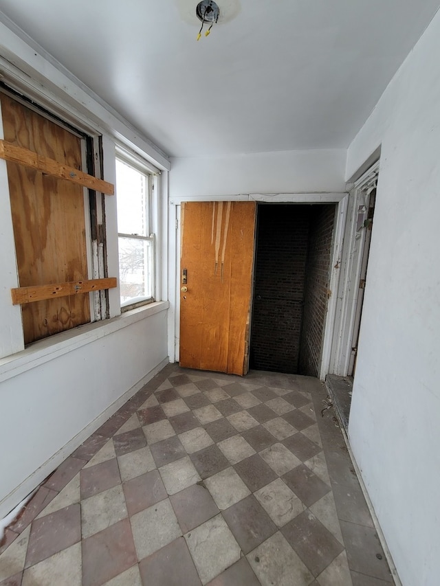 unfurnished bedroom with tile flooring and a closet