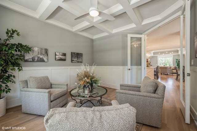 living room with ceiling fan, beamed ceiling, coffered ceiling, and hardwood / wood-style flooring