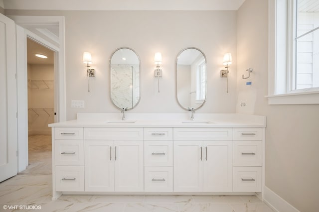 bathroom with vanity with extensive cabinet space, dual sinks, and tile floors