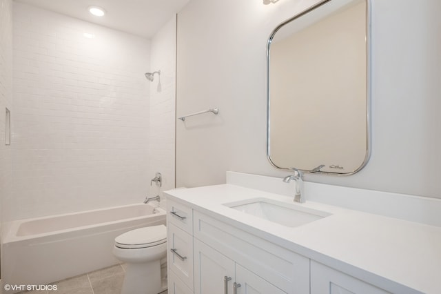 full bathroom featuring tiled shower / bath, vanity, toilet, and tile floors