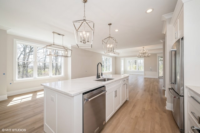 kitchen featuring a center island with sink, light wood-type flooring, white cabinets, sink, and appliances with stainless steel finishes