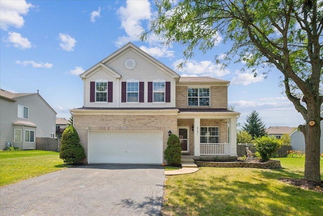 front facade with a front lawn, a garage, and covered porch