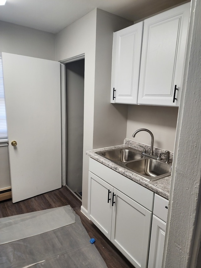 kitchen featuring white cabinetry, sink, and dark wood-type flooring