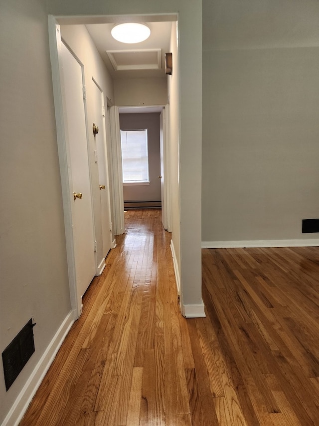 hall featuring light hardwood / wood-style floors and a baseboard radiator