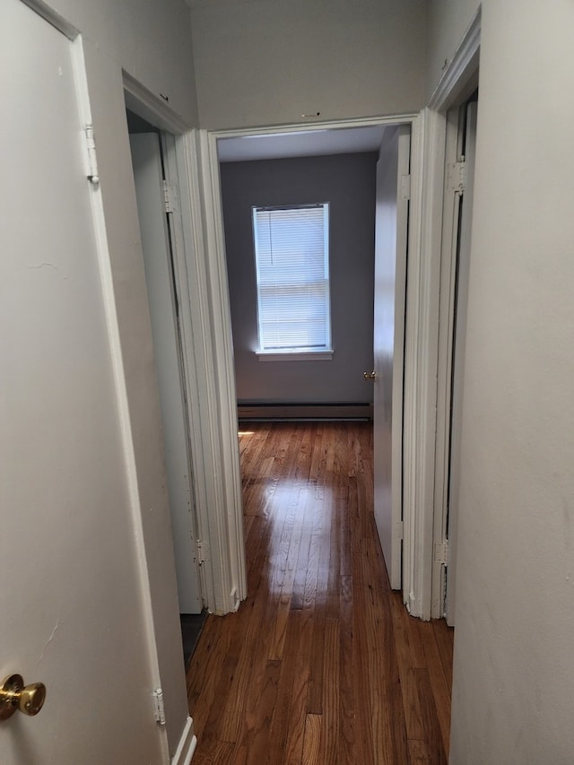 hall featuring a baseboard radiator and dark hardwood / wood-style floors